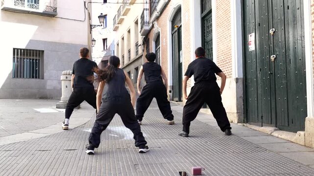Group of professional street dancers performing modern choreography
