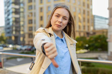 Dislike. Upset Caucasian mature businesswoman showing thumb down sign gesture, expressing...