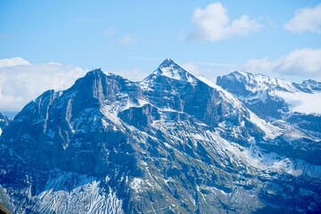 Snow-covered peaks of the Swiss Alps under a blue sky