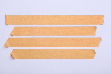 Strips of brown masking tape on white background