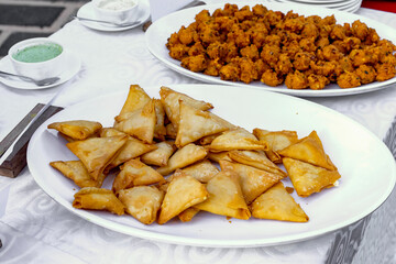 Delicious Indian Samosas and Appetizers Served on a White Platter
