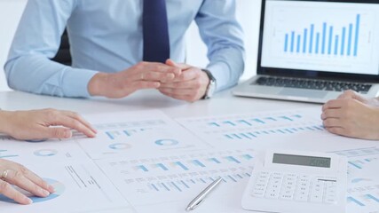 Business people having a financial meeting, discussing company strategy, reviewing data analysis, and planning future growth using charts and reports - Powered by Adobe