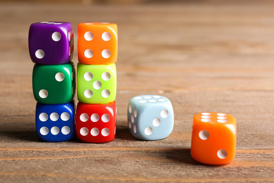 Colorful dices on wooden background