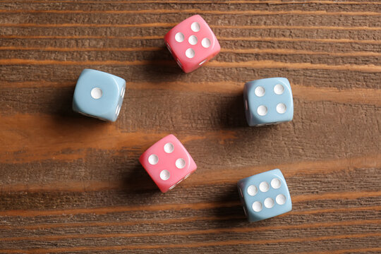 Different dices on wooden background