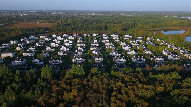 Aerial drone view of luxury home enclave in autumn landscape at sunrise