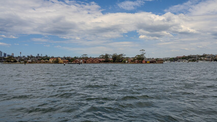 Residential Houses and apartment buildings on Parramatta River Sydney Harbour on a warm spring cloudy overcast day in Sydney NSW Australia