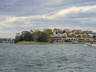 Residential Houses and apartment buildings on Parramatta River Sydney Harbour on a warm spring cloudy overcast day in Sydney NSW Australia