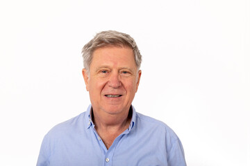 Fototapeta premium portrait of attractive handsome senior man with grey hair smiling and looking happy