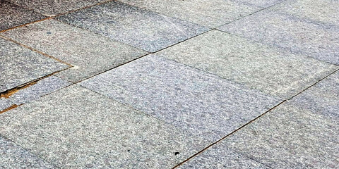 Close Up View Of Weathered Granite Paving Stones With Visible Texture And Cracks