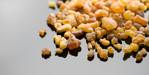 Frankincense olibanum resin, Boswellia sacra resin on grey background. Frankincense or olibanum aromatic resin, incense and perfumes. Top view. Medicine, religion concept. Incense, Fragrance 