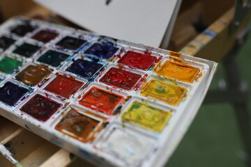 A close-up of vibrant, colorful paints. Preparing for watercolor painting.