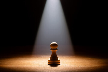 A lone pawn in light and shadow, representing the internal struggle of growth and self-discovery.
