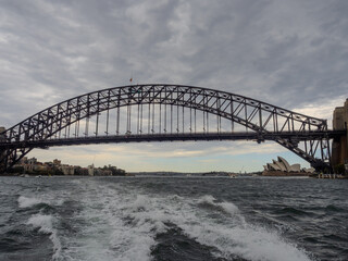 Naklejka premium 11 October 2025 Sydney Harbour Bridge at Circular Quay on Sydney Harbour on a cloudy cool spring Day in Sydney NSW Australia