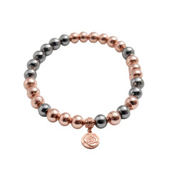Fototapeta premium Elegant beaded bracelet with rose gold and silver tones and charm