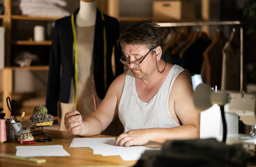 Sad man tailor reads business paper report
