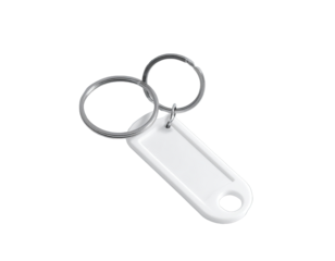 White, blank keychain tag with silver rings on dark background
