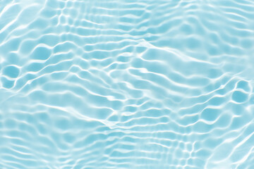 Blue water with ripples on the surface. Defocus blurred transparent blue colored clear calm water surface texture with splashes and bubbles. Water waves with shining pattern texture background.