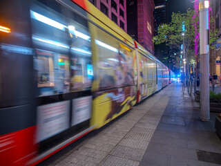 11 October 2025 tran going up and down George Street in the heart of Sydney CBD on a warm spring night with the tram having motion blur Sydney NSW Australia