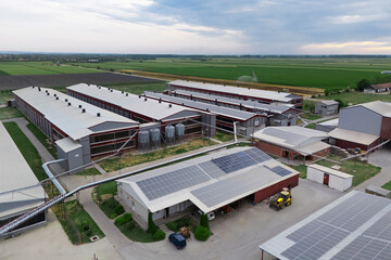 Modern poultry farm with solar panels. Factory using renewable energy. Aerial view