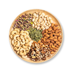 Assorted healthy nuts including almonds, cashews, walnuts, pistachios, macadamias, and pumpkin seeds on wooden plate. Organic superfood rich in protein, vitamins, and nutrition for clean eating.
