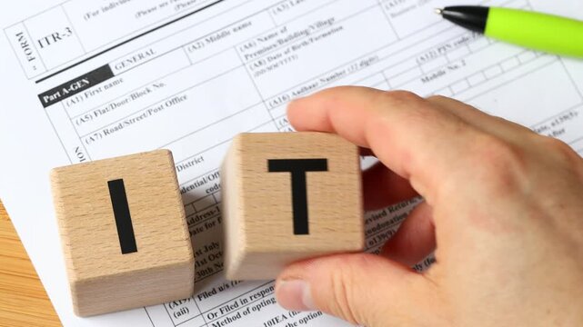  India taxes. ITR3 tax form with PAN number. Indian income tax return. Text on wooden blocks. Financial concept. close up.