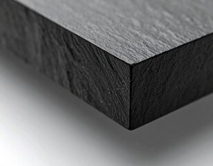 Close up view of dark slate stone texture with rough layered edge.