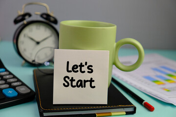 text Lets start on a green mug isolated blue background