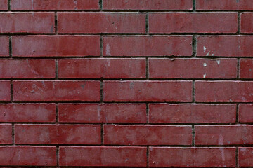 Deep red brick wall offers a rustic, textured surface for a vintage or industrial background design