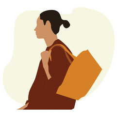 woman carrying a bag on her shoulder. looking over her shoulder while carrying a large brown tote bag.