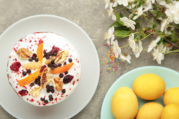 Traditional easter cakes with colorful sprinkles, with eggs, a bunny figurine, and spring flowers, creating a festive holiday scene