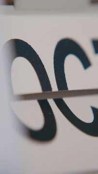 Close-up shot of month field on a flip calendar rapidly changing