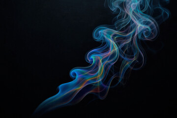 Fototapeta premium Colored smoke on a black background in artistic lighting. Space for text.
