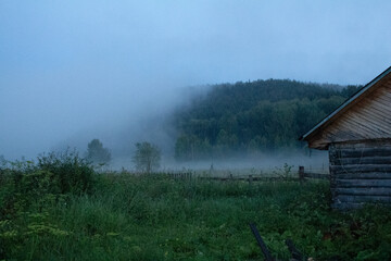 A village at sunset in the fog