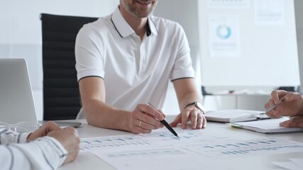 Professional business team reviewing financial data, collaborating over charts and graphs with laptop and pen in contemporary workplace, emphasizing strategic analysis and teamwork - Powered by Adobe