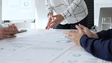 Business people team analyzing financial charts during strategy meeting, professionals discussing data and performance metrics at workplace for decision making success - Powered by Adobe