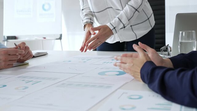 Business people team analyzing financial charts during strategy meeting, professionals discussing data and performance metrics at workplace for decision making success - Powered by Adobe