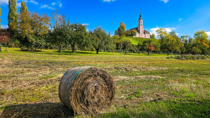 Pilgrimage church Birnau in autumn day with a straw bale in the foreground. Lake Constance, Baden-Wurttemberg, Germany.