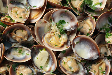 Steamed Clams with garlic, parsley and white wine in a cast iron pan