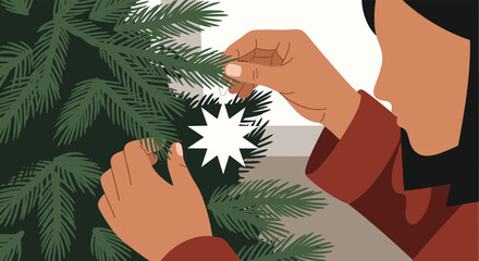 Person decorating Christmas tree with star ornament