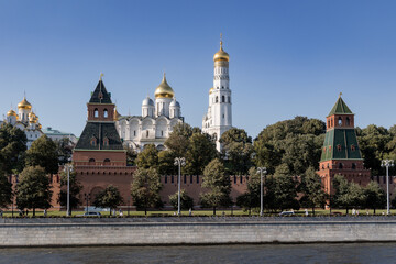 Historic center postcard Kremlin Tower, church with golden dome on sunny day, Moscow, Russia