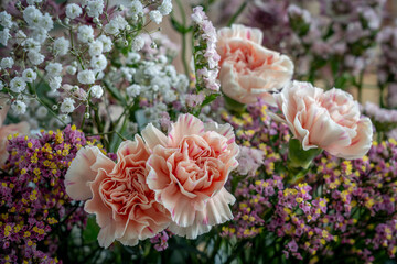 Paris, France - 11 10 2025: Close up shot of a bouquet of colored flowers and roses on a wooden table