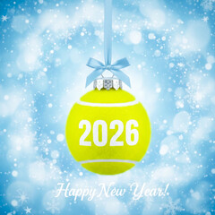 Tennis Ball Christmas Ornament With 2026 Text Hanging On Blue Snowy Background. Concept Of Sporty New Year Greeting, Holiday Decoration, Tennis Fan Gift Idea, And Seasonal Event Visuals
