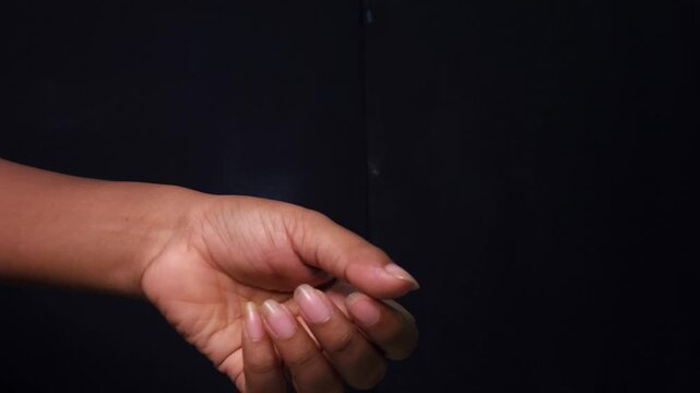 Male and female hands hand gesture on black isolated background. Imitates sex. A vulgar and exciting hand sign. Indecent hand gestures that show how sex happens. imitation penis and vagina.