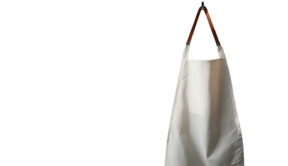White apron hangs against black, with brown leather straps showing
