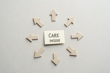 Arrangement of Paper Arrows Pointing Inward Toward Care Inside