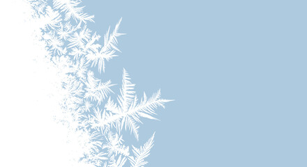 Delicate frosty ice crystals forming intricate patterns on a cold surface.