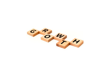 Wooden blocks spelling 'Growth' on a white background, symbolizing business development and success, concept of improvement