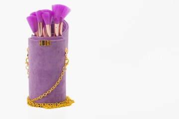 A purple purse with a chain hanging from it