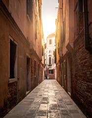 Fototapeta premium A sunlit alleyway in a European city with brick and plaster buildings