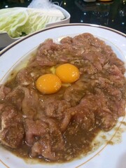 Marinated pork with fresh eggs for Thai-style sukiyaki